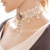 The Samantha Choker - A delicate white lace choker adorned with pink roses, faux pearls, and bronze hardware.