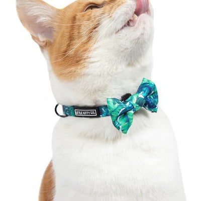 Little Kitty Co. Cat Collar & Bow Tie - Vacay Palms (Limited Edition) - A vibrant green cat collar with a leaf motif. It has a white cat-shaped buckle, a black bell, and a matching bowtie that can be attached with velcro.