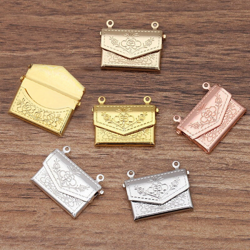 Lovely Lockets - Floral Envelope - A tiny metal envelope-style locket with a pretty floral pattern embossed in it, available in several shades of gold and silver.