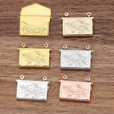 Lovely Lockets - Floral Envelope - A tiny metal envelope-style locket with a pretty floral pattern embossed in it, available in several shades of gold and silver.