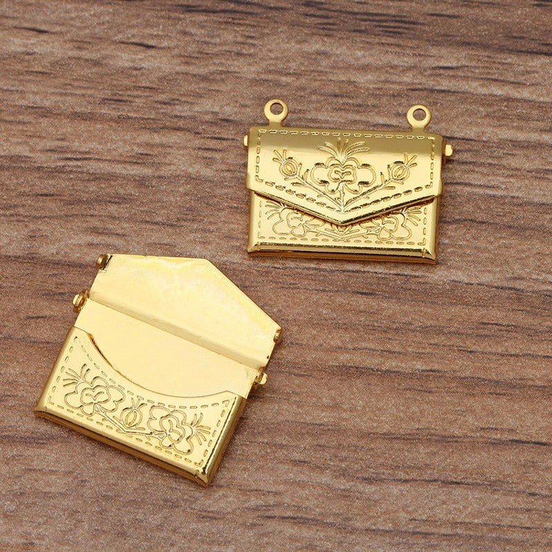 Lovely Lockets - Floral Envelope - A tiny metal envelope-style locket with a pretty floral pattern embossed in it, available in several shades of gold and silver.
