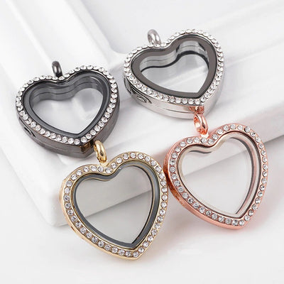 Kalliope Magnetic Floating Locket - A heart-shaped locket with glass panels in the front and back, allowing the user to place whatever they want on display in between. It is available in gold, gunmetal (dark silver) rose gold, or silver, and in either jewelled or etched/carved.