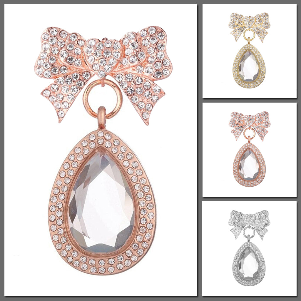 Melpomene Magnetic Brooch Locket - A crystal-encrusted brooch with a droplet shaped floating locket attached.