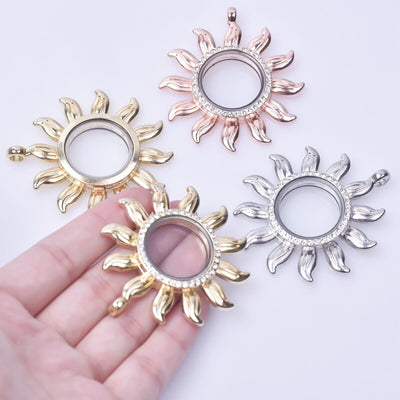 Apollo Magnetic Floating Locket - A locket shaped like a sun, which has a glass panel that can be opened to place trinkets or photographs inside. Available in yellow gold, rose gold, or silver coloured.