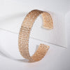 Petrina Woven Cuff Bracelet - A beautiful rose gold bangle that looks like it's made out of plaited or braided strands of gold.