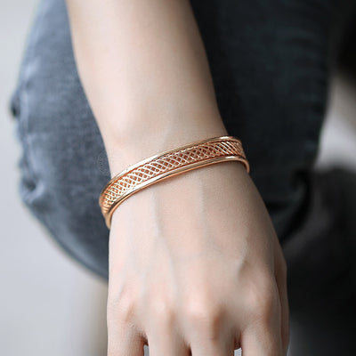 Alicia Woven Cuff Bracelet - A beautiful rose gold bangle that looks like it's made out of plaited or braided strands of gold.