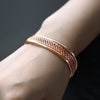 Alicia Woven Cuff Bracelet - A beautiful rose gold bangle that looks like it's made out of plaited or braided strands of gold.