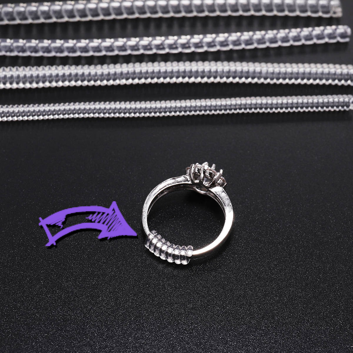 Ring Size Adjuster - Spiral - A small coil of PVC designed to be wrapped around the underside of a ring to make a large ring fit more closely to the wearer's finger.
